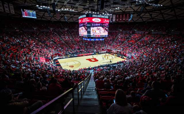 Interior of Huntsman center from up high, big U in the basketball court with all the arena seats filled