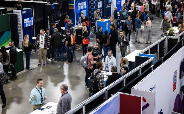 Aerial view of the connection corridor at summit 2026 with lots of people and booths