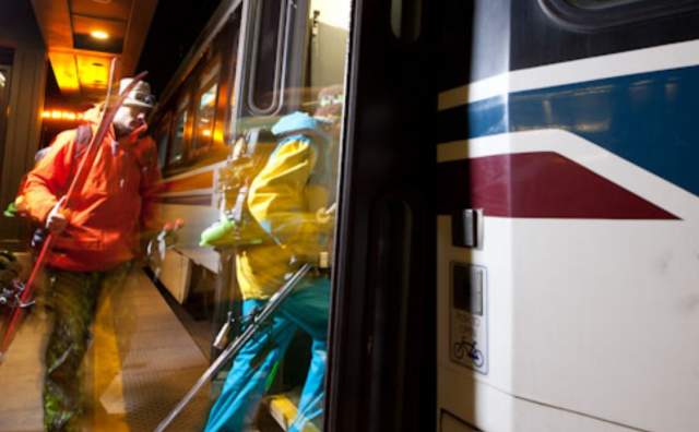 Skiers boarding a Utah Transit Authority TRAX car