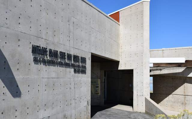 Concrete building with interesting angles that shows the entrance to the Antelope Island State Park Visitor Center