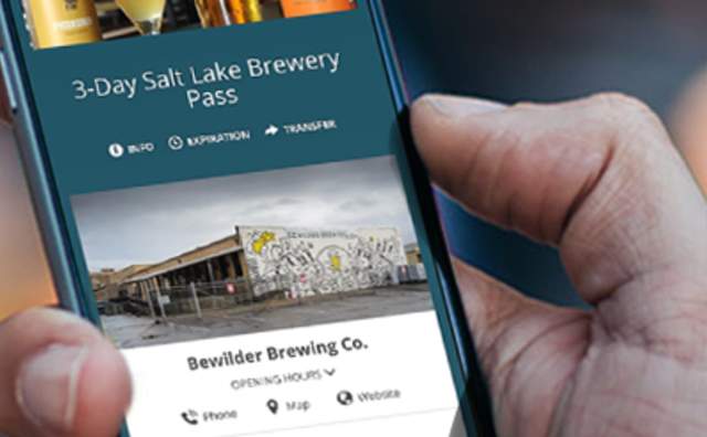 Hand holding phone with the Brew Pass on it