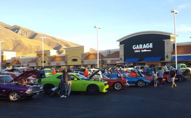 Exterior photo of Garage Grill showing colorful cars with raised hoods