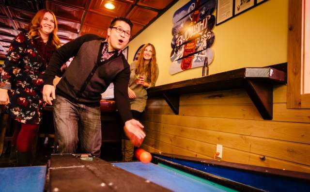 Playing skeeball at Gracies Bar