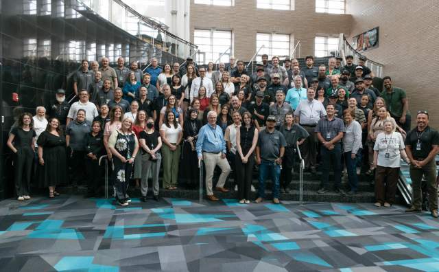 Photo of the Salt Palace Convention Center and Mountain America Expo Center all staff photo on staircase inside the Salt Palace Convention Center.