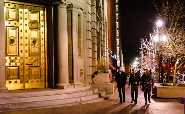 A group of 3 friends walking on the street in downtown Salt Lake at night
