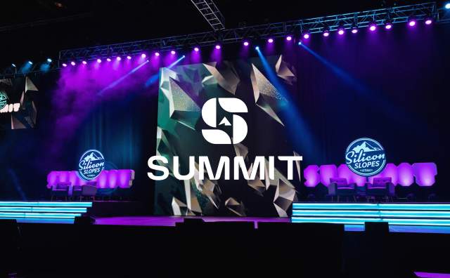 Stage setup with purple and blue lights, logos that say Silicon Slopes and a Summit Logo overlay