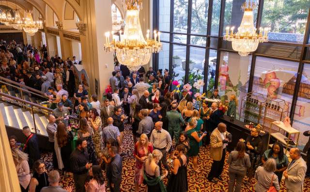 Aerial view of crowd of people networking and talking in the lobby of the Capitol Theater