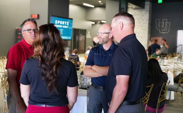 Clay Partain  speaking with a few people