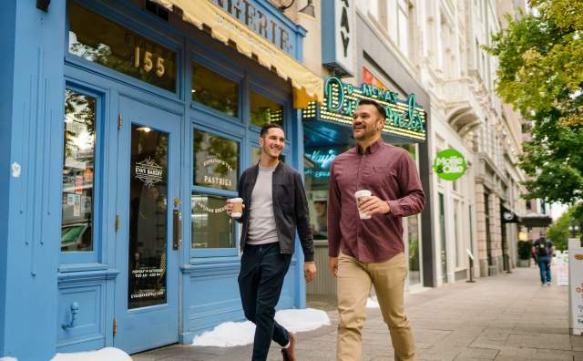 Couple Walking Past Eva's Bakery