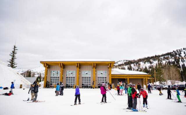 View of the Milly Chalet with skiers and snowboarders