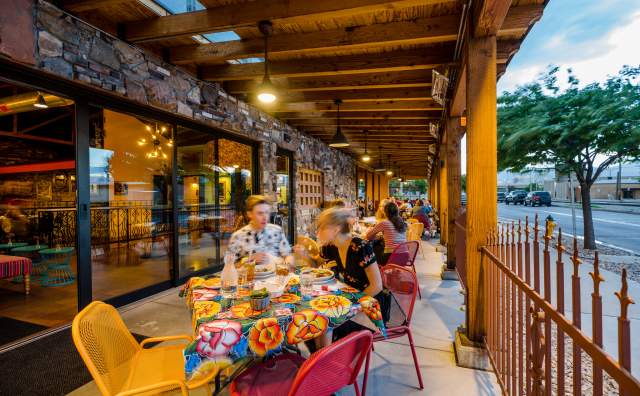 Image of people eating on the patio of Red Iguana 2