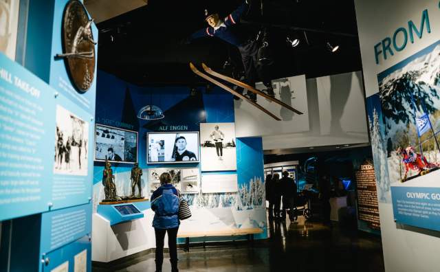 A woman looking at an exhibit at the Utah Olympic Park Museum