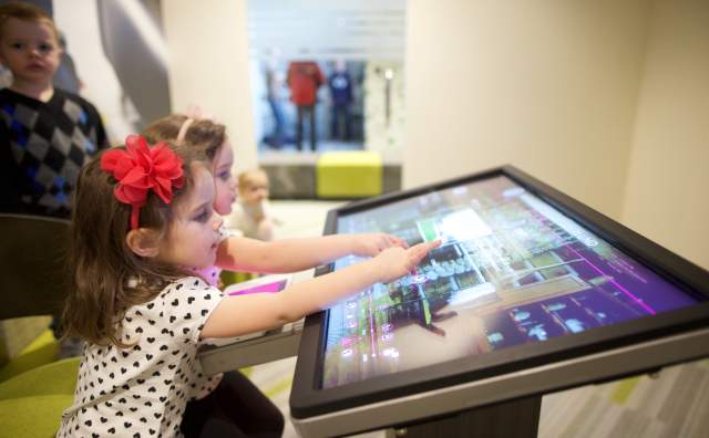 Two children explore the family's history in The Time Machine at the Family History Library in Salt Lake City, Utah.
