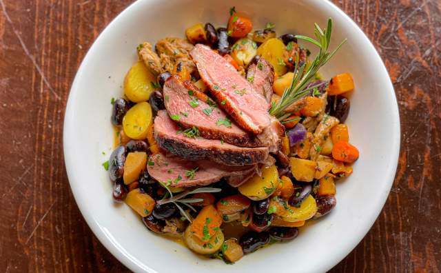 Plate of food with vegetables and meat arranged in an array