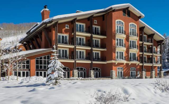 Exterior image of 4 story building with snow on the ground and roof