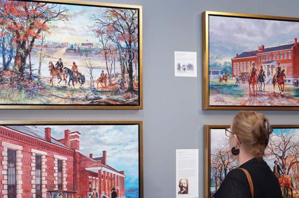 Women viewing John Bell paintings