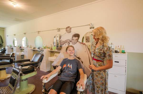A child sits in the Elvis chair at the Chaffee Barbershop Museum, Fort Smith, Arkansas.