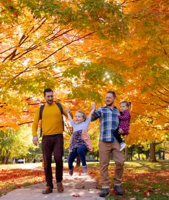 A family of two dads and their daughters walking through Aldo Leopold Nature Center.