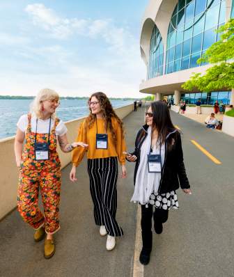 Three meeting attendees walking along the path near Monona Terrace
