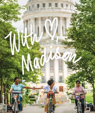 The cover of "With Love, Madison" featuring three people biking in front of the Capitol. Two of the people are holding hands while biking.