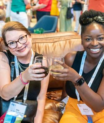 Two meeting attendees in Madison cheers with drinks