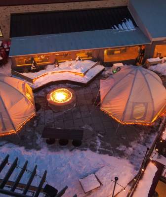 Aerial photo of two domes covered in snow outside on the patio of Lone Girl Brewing Company