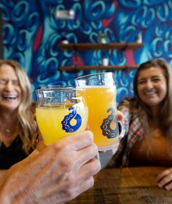 Two women cheers beer at Octopi Brewing in Waunakee.