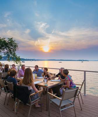 People dining on an outdoor patio at The Edgewater