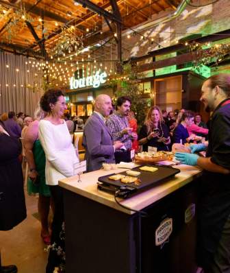 Event attendees in line for food at Garver Feed Mill reception