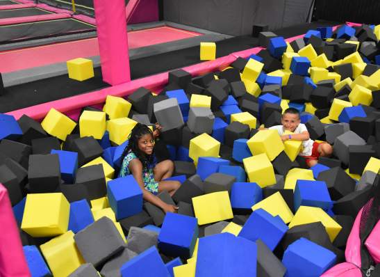 boy and girl playing in large foam blocks