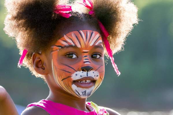 Young girl with face painted at downtown event