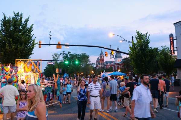crowd shot of summernight downtown art walk with Samford Hall in background