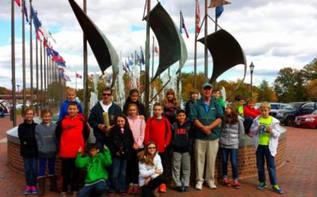 Private Tours group picture in front of flags