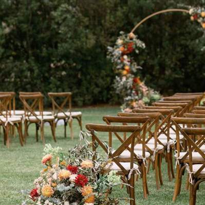 Flowers and chairs set up for an outdoor wedding