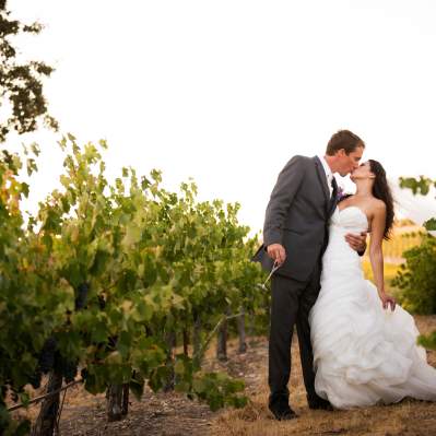 Wedding couple kissing in a vineyard
