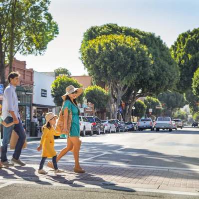 Family of four walking across a street in Downtown San Luis Obispo