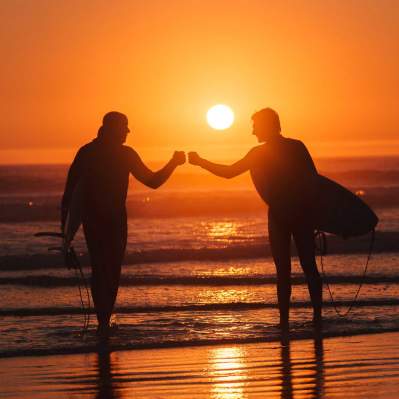 Surfers in the Sunset