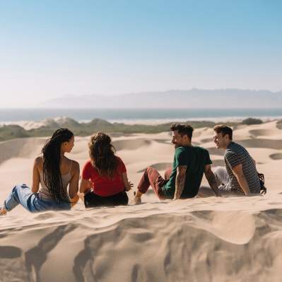Friends sitting on the Oceano Dunes