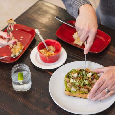 A couple eating plates of food from Grover Beach Sourdough