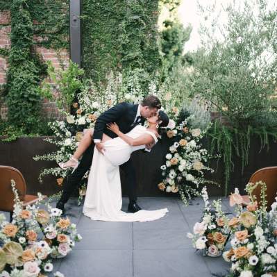 Wedding couple kissing in an outdoor venue