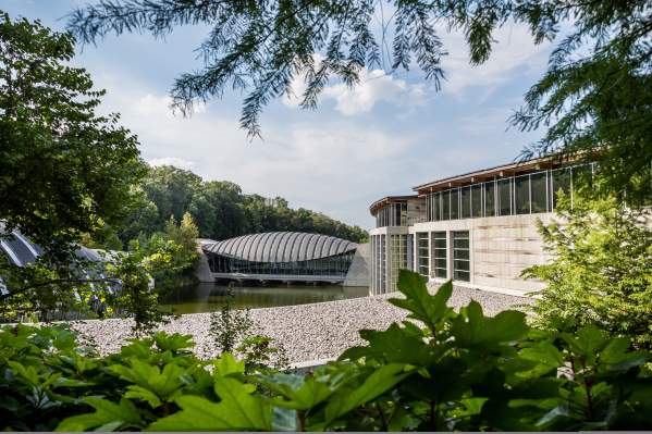 Crystal Bridges Museum of American Art with the edges of the image covered in green foliage