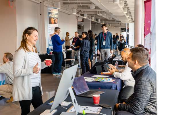 Professionals networking at a business event inside The Ledger in Bentonville, AR.
