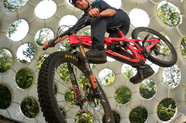 A man riding a bike inside Fly's Eye Dome - A public art piece at Crystal Bridges Museum of American Art