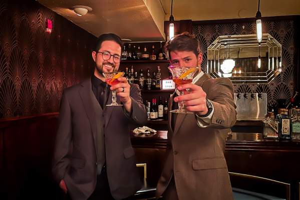 Two people getting drinks at the downstairs speakeasy at Kress Cinema & Lounge