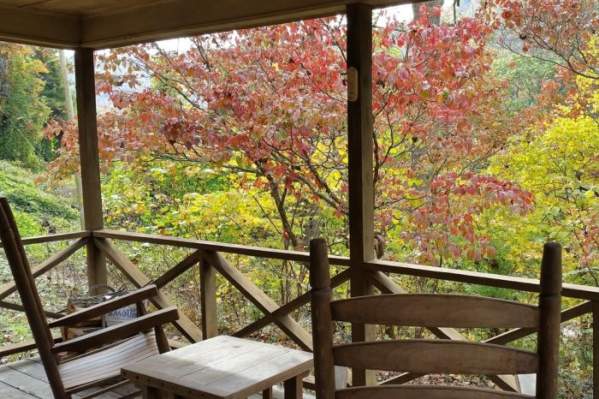 chairs on porch overlooking trees