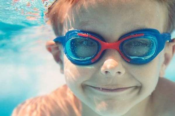 child wearing goggles underwater
