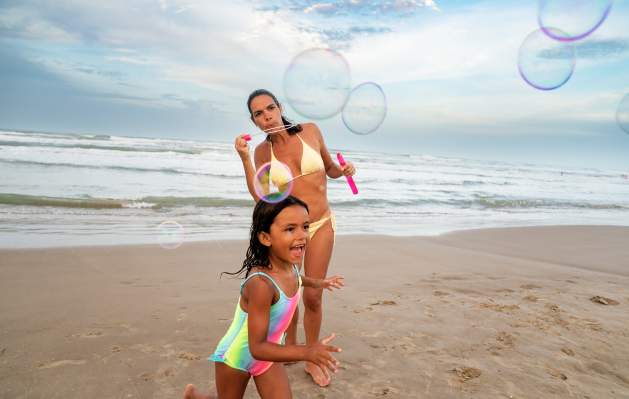 Mom and Daughter Playing on the Beach