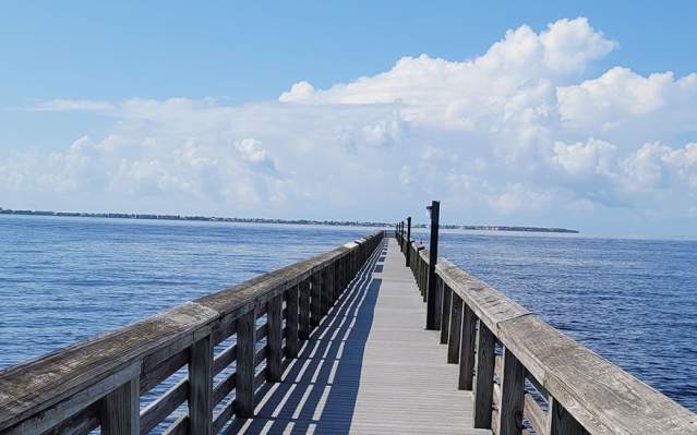 Fishing pier over blue water