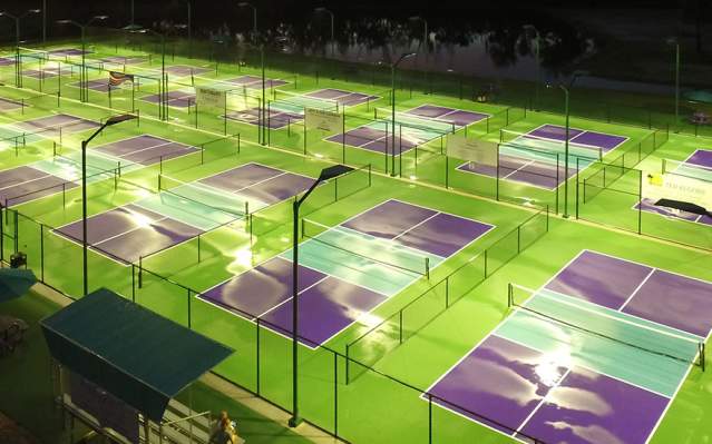 Aerial view of Pickleplex® of Punta Gorda courts lit up at night