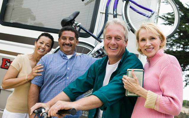 Two couples near an RV